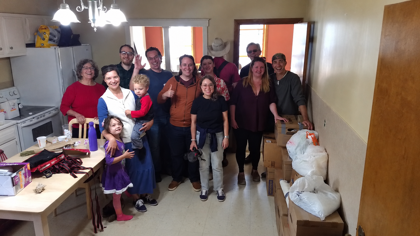 Free Staters and a family gathered in a new home during a Welcome Wagon.
